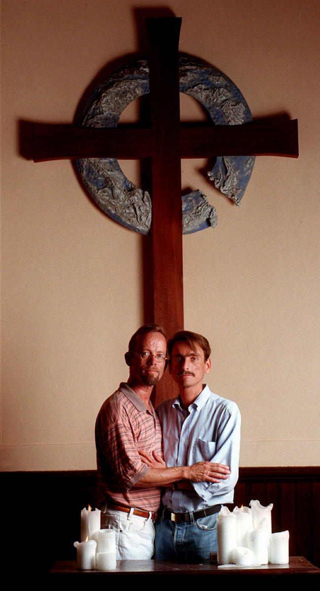 A couple pose in church days before their marriage.