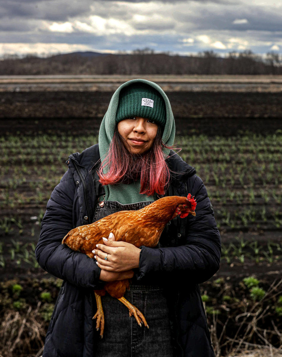Jennifer Angel, 19, holds Canela, a chicken that has become a family pet, at her families farm in Goshen, N.Y. April 10, 2022.