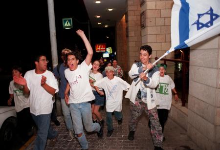 Supporters of Israeli Prime Minister Shimon Peres celebrate prematurely on the evening of the 1996 elections. Peres would end up losing the election to Benjamin Netanyahu.