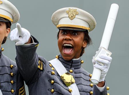 A member of the United States Military Academy graduating class of 2014 points to family after receiving her diploma during commencement exercises at West Point.